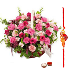 Pretty Gift Arrangement of Roses and Seasonal Flowers in a Basket with free Rakhi Roli Tika and Chawal for Special Rakhi Festival<br>