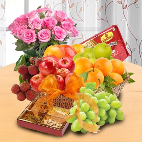 Basketfull of Fresh Fruits Basket & Soan papdi decorated with Pink Rose Bouquet for your Mummy